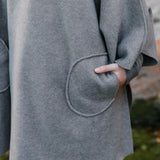 Fleece fabric cape with pockets